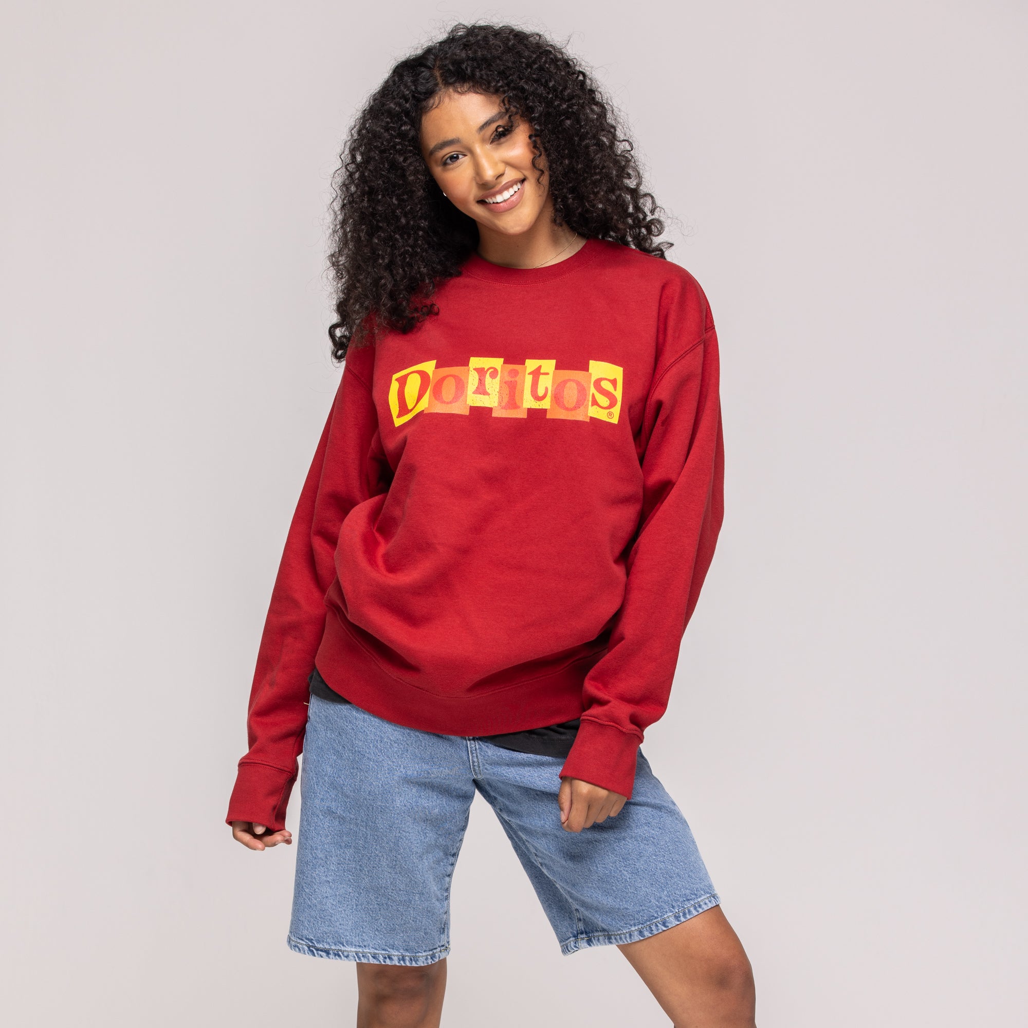 Red crewneck sweatshirt with yellow and orange block-letter 