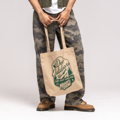 Tan canvas tote bag, green badge graphic reading 