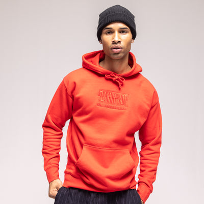 Model in a red hoodie with tonal embroidered 