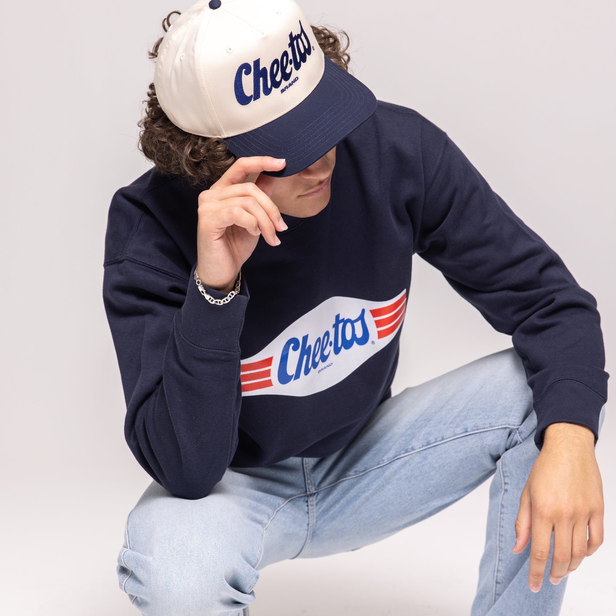Navy crewneck sweatshirt, white banner graphic with 