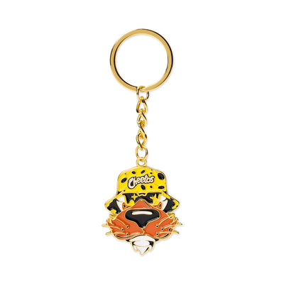 Gold enamel keychain featuring Chester Cheetah face wearing a yellow cheetah-print bucket hat with 