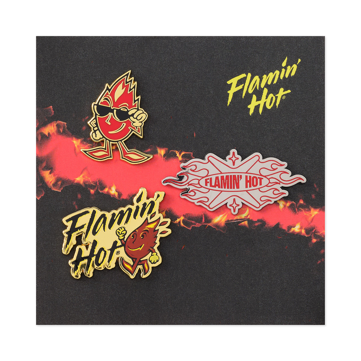 Three Flamin' Hot enamel pins on a black and red flame card: Sparky mascot in sunglasses, silver 