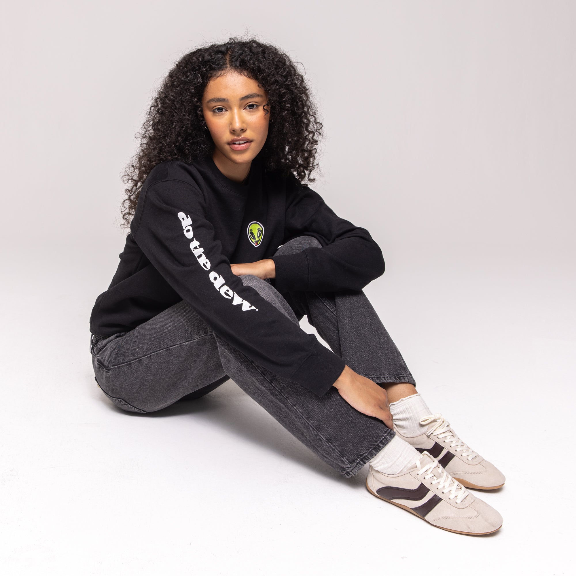 Black crewneck sweatshirt with green alien patch and white 