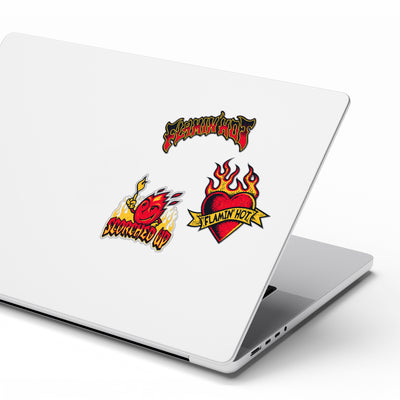 White laptop with three Flamin' Hot stickers: flame lettering logo, 