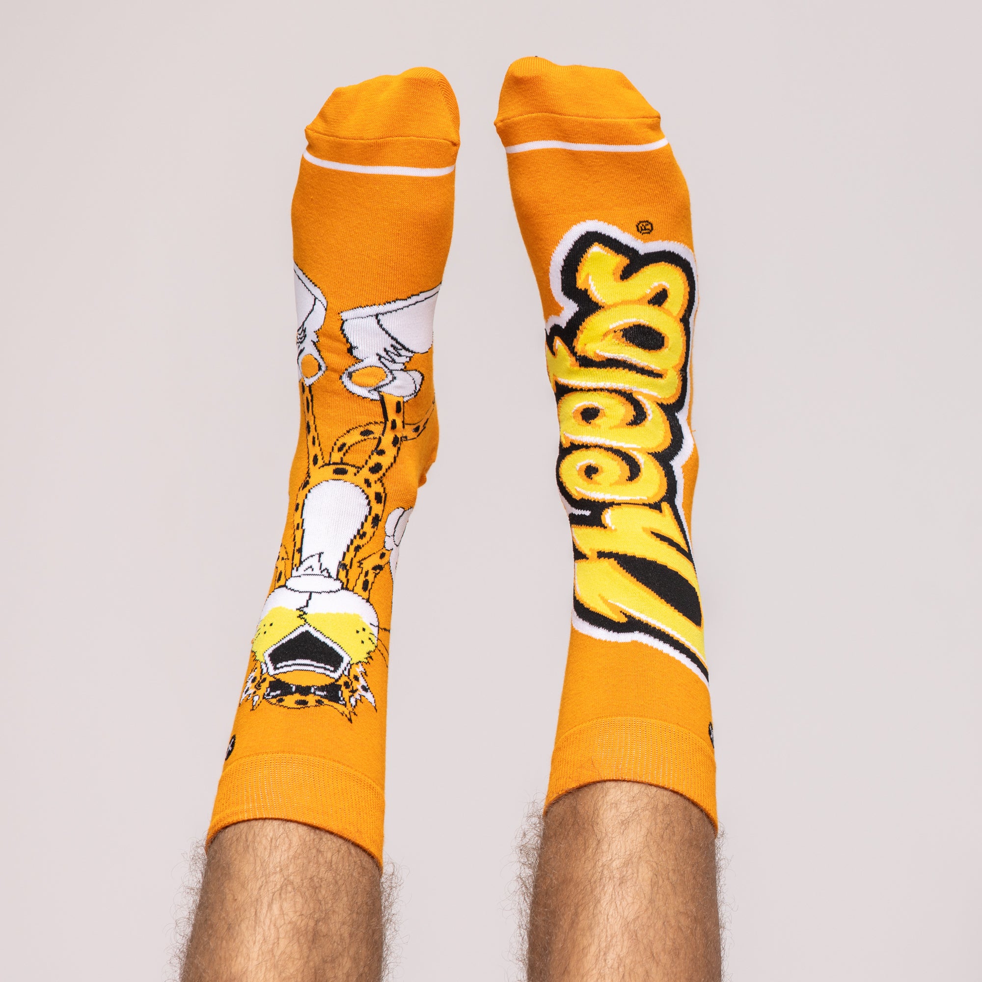 Orange crew socks featuring Chester Cheetah and yellow 