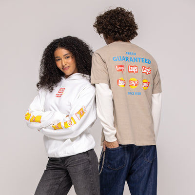 White Lay's hoodie with chip-bag sleeve print beside beige tee, back reads 